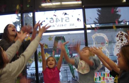 children in a vancouver day care playing games while it rains outside